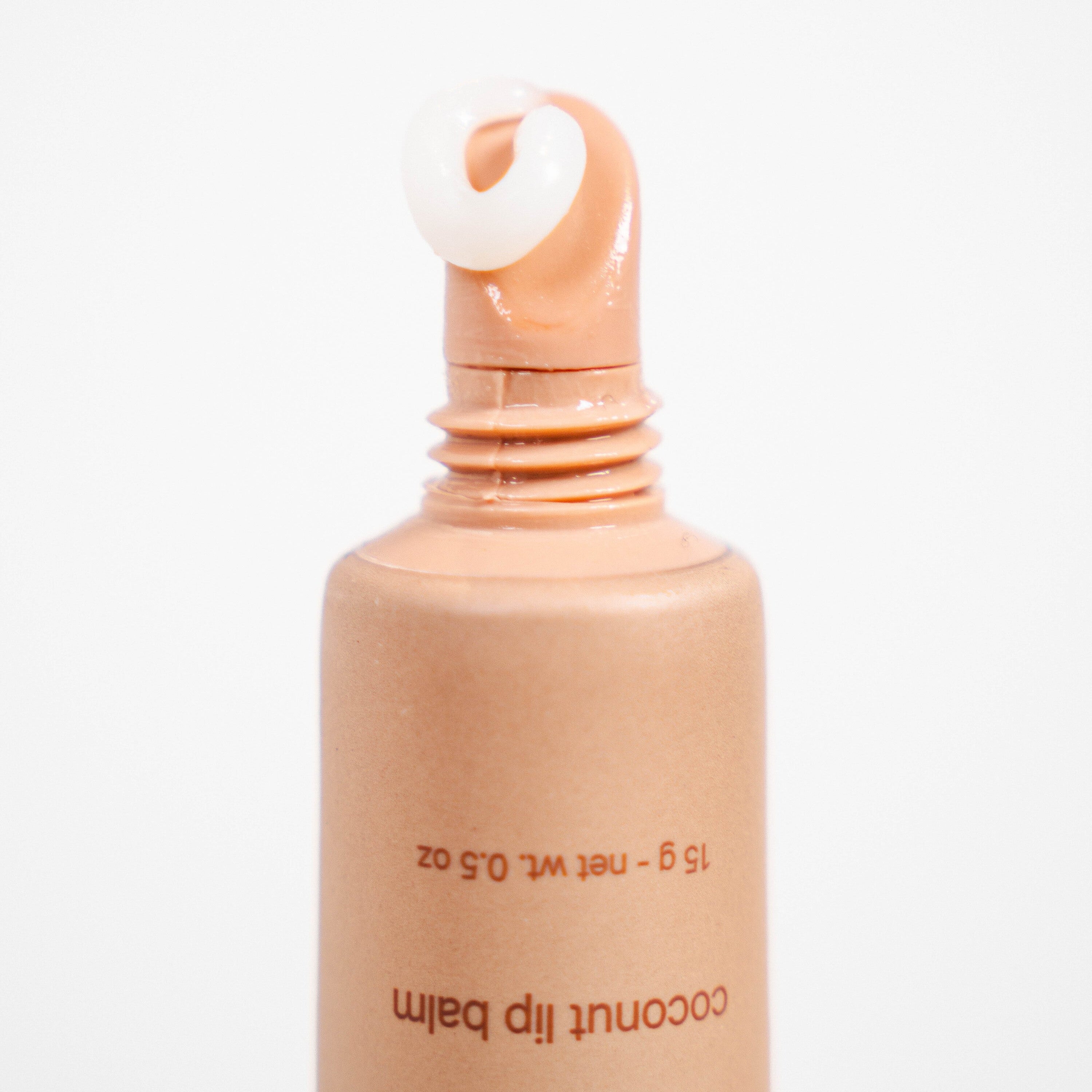 Smooth coconut lip balm flowing out of it's packaging.