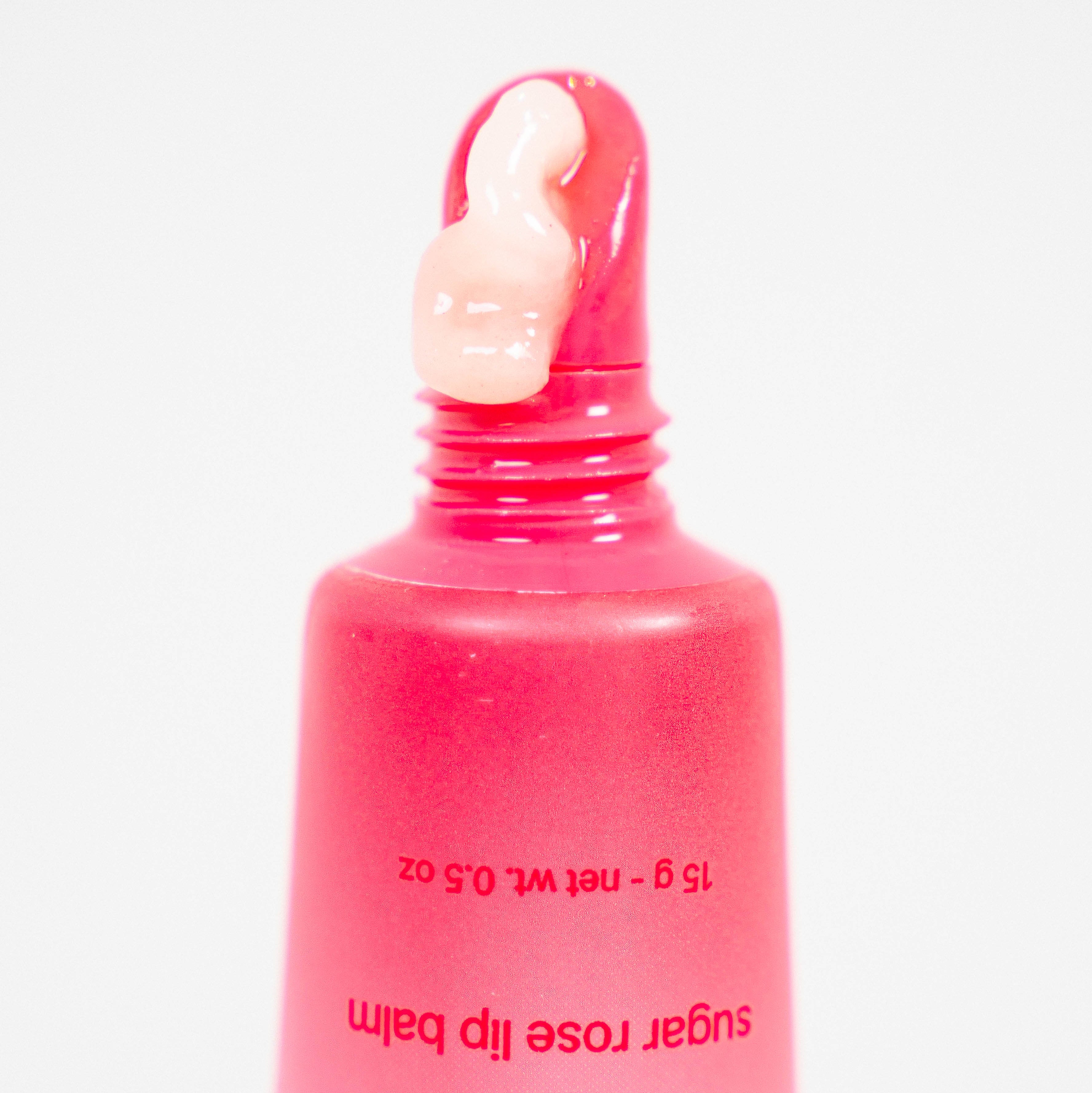 Sugar rose lip balm flowing out of it's packaging.