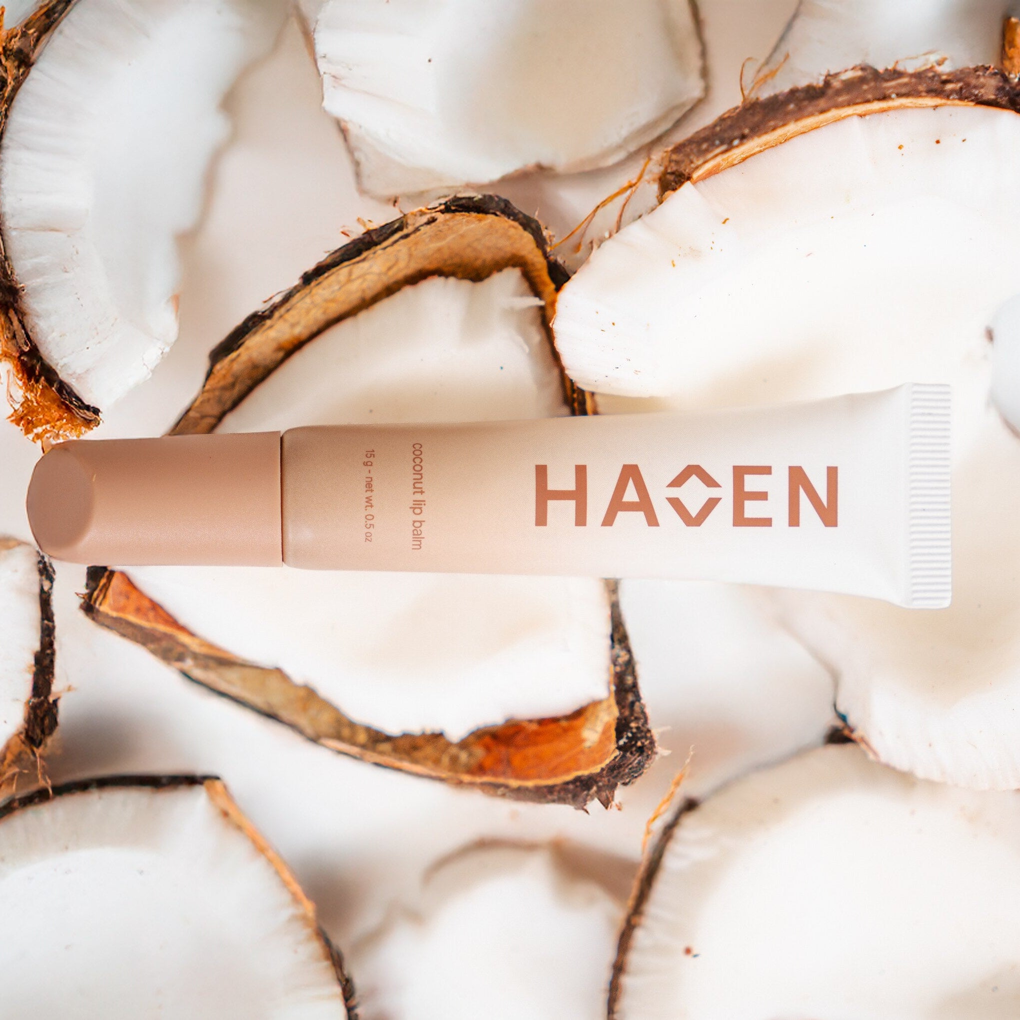 Lip balm laying on real coconut.